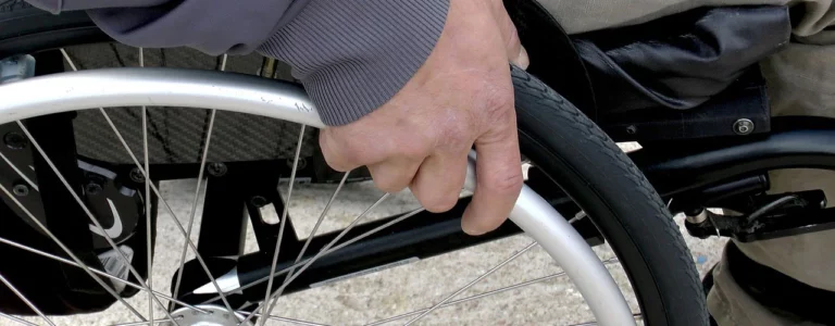 Hand on wheelchair wheel