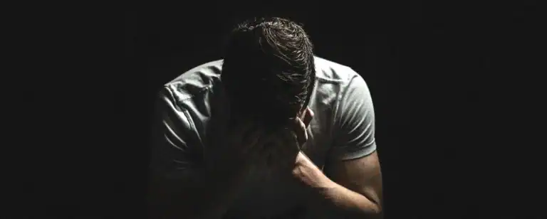 Emotional man holding his head in his hands