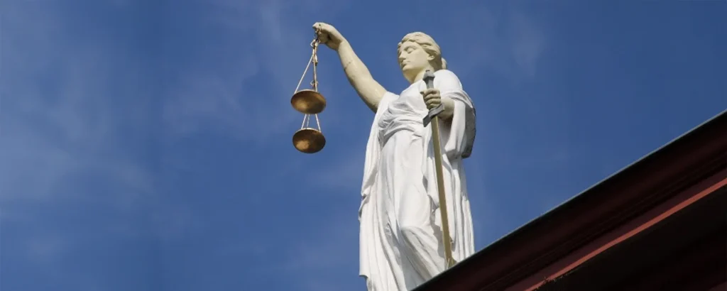 White marble statue of justice holding scales